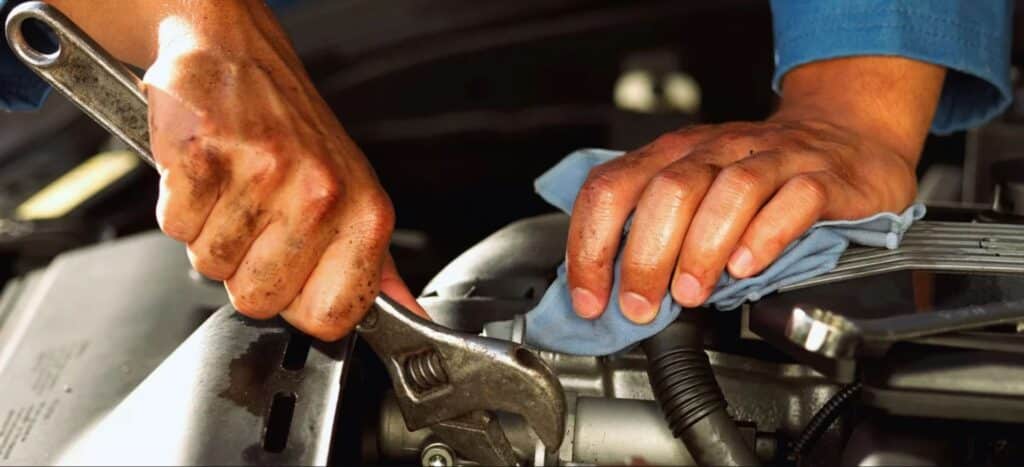 hands working on a car
